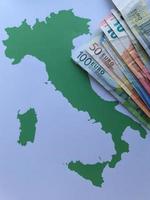 billets de banque européens et arrière-plan avec la silhouette de la carte de l'italie photo