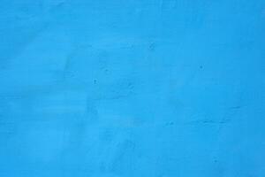 Contexte de une bleu peint ciment mur, rugueux jeter de ciment et béton mur texture, décoratif rustique enrobage photo