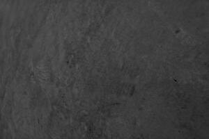 pierre de granit nature granitoïdes surface rugueuse surface finie mur, matériau de sol fond de couleur noir et gris, a toujours une texture serrée, durable photo