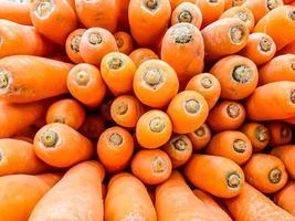 carotte bio. fond de texture de grosses carottes oranges fraîches, les carottes sont bonnes pour la santé, carottes mûres saines pour préparer le repas photo