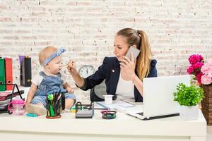 famille affaires - télétravail femme d'affaires et mère avec enfant est fabrication une téléphone appel photo