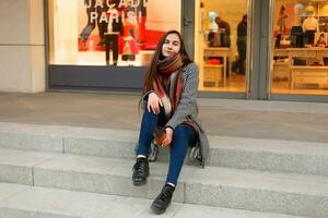 Dame avec une tasse de café en marchant vers le bas le ville rue photo