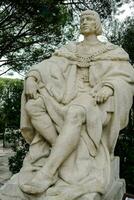 une statue de une homme séance sur une pierre banc photo