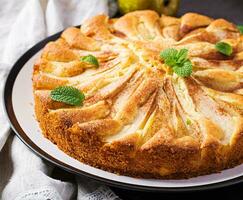 fait maison tarte avec poires et amande farine sur foncé Contexte. photo