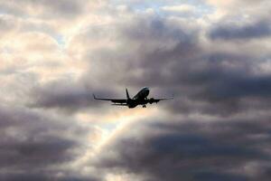 une avion en volant par le nuageux ciel photo