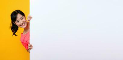 Jeune asiatique des sports aptitude femme content sourire portant rose tenue de sport permanent derrière le blanc Vide bannière ou vide espace publicité planche contre Jaune Contexte. bien-être mode de vie concept. photo