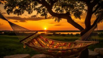 ai généré une hamac pendaison en dessous de une arbre à coucher de soleil, fournir une serein et paisible place à se détendre et prendre plaisir le magnifique soir ciel. génératif ai photo