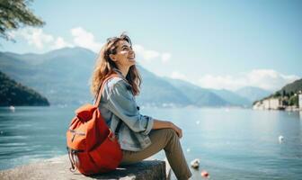 ai généré une femme séance sur le rive de Lac Côme en portant sa sac à dos tandis que souriant photo