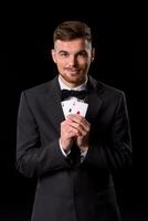 homme dans une costume posant avec cartes photo