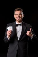 homme dans une costume posant avec cartes photo