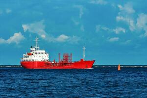 rouge cargaison pétrolier navire en mouvement par le rivière photo