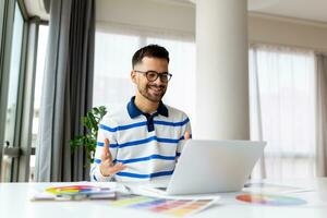 portrait de Masculin intérieur designer travail à Bureau avec Couleur échantillons. homme à lieu de travail choisir coloré échantillons, fermer. Créatif gens concept. photo