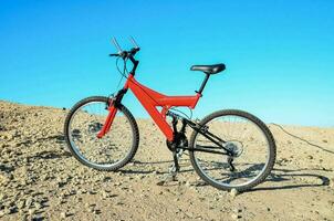 une rouge Montagne bicyclette sur une désert plaine photo