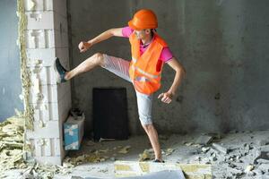 profession, construction et bâtiment - content souriant ouvrier ou constructeur dans casque plus de pièce avec travail équipement à Nouveau Accueil ou appartement Contexte photo