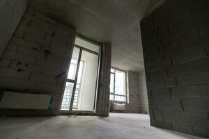 petit appartement sans pour autant réparation dans une Nouveau bâtiment. une pièce dans un inachevé maison. des murs de mousse bloquer et béton sol dans une minuscule appartement. photo