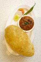 Indien cuisine cholé bature aussi connaître comme poussin pois curry, cholé bhture ou Chola, chana Masala servi avec frit puri est une plat de le punjab photo