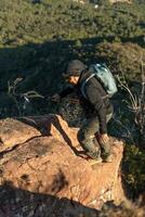 âge moyen homme grimpe le Montagne dans le garraf Naturel parc, prise en charge par randonnée poteaux. photo