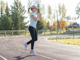 une Jeune magnifique femme dans tenue de sport pièces des sports à une local stade photo