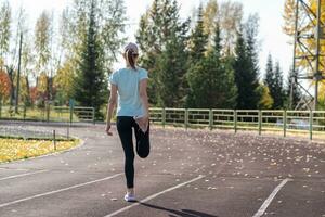 une Jeune magnifique femme dans tenue de sport pièces des sports à une local stade photo