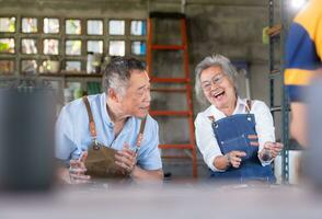 portrait de une Sénior asiatique couple Faire Activités ensemble dans le poterie atelier. photo