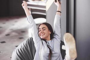 la femme joue sur la console et elle est heureuse de gagner, lève les bras et sourit photo