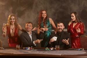 groupe de une Jeune riches copains sont en jouant poker à une casino. photo