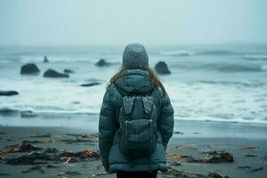 ai généré hiver solitude fille dans vers le bas veste des stands sur rivage contemplant photo