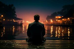 ai généré réfléchissant nuit adapté homme est assis à Dock bord dans contemplation photo