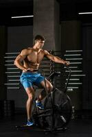 athlète homme Cyclisme dans le salle de sport. photo