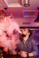 vapoter. vapoter homme dans une nuage de vapeur. photo est pris dans une vape bar.