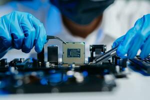 le technicien est en mettant le CPU sur le prise de le ordinateur carte mère. électronique ingénierie électronique réparation, électronique photo