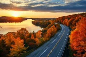 ai généré aérien vue de Montagne route dans forêt à le coucher du soleil dans l'automne. Haut vue de drone de route dans les bois. magnifique paysage avec chaussée dans collines, pin des arbres, vert prés photo