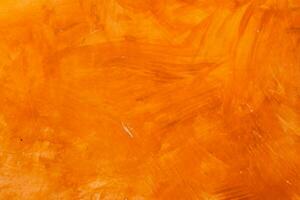 texturé mur brossé peint arrière-plan, abstrait Orange pétrole couleur. photo