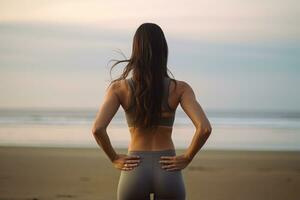 ai généré retour vue de sportif Jeune femme dans tenue de sport permanent sur plage et à la recherche loin, retour vue de femme athlète dans tenue de sport Faire élongation et chaud en haut pour mains en plein air sur océan plage photo