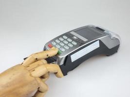 main en bois sur une machine edc ou un terminal de carte de crédit pour effectuer un paiement en ligne. photo