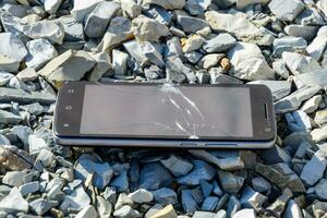 frustré téléphone sur le rochers. verre brisé sur rochers sur une sma photo