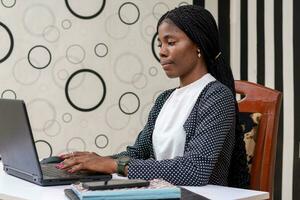 magnifique africain femme d'affaires sérieusement travail sur le système à propos le entreprise affaires photo