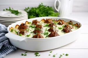 ai généré casserole avec blanc sauce et Boulettes de viande dans une blanc céramique former. génératif ai photo