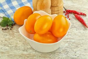 douce tomate jaune mûre dans le bol photo