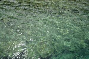 surface de le mer dans peu profond eau, somnolent éblouissement sur le vagues. photo