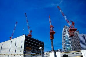 grues à le Haut de le bâtiment à le affaires ville dans tokyo large coup photo