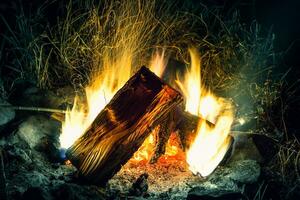 magnifique feu avec en volant des étincelles modèle. grand bois de chauffage Feu brûler dans pas obscurité photo
