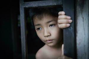 le enfant capturé le le fer cage avec tristesse et désespoir. le concept de arrêt la violence contre les enfants et Humain trafic. enfant abus, la violence contre les enfants. photo