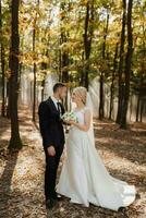 le la mariée et jeune marié sont dansant contre le Contexte de une Conte de fée brouillard dans le forêt. le des rayons de le Soleil Pause par le fumée, une Conte de fée mariage photo