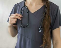 coup de le femelle médecin dans uniforme contre le blanc mur. soins de santé photo