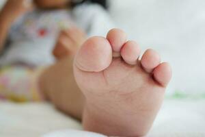 fermer de sec enfant pieds sur lit , photo