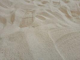 chaussure impressions dans le le sable sont pas clair. photo