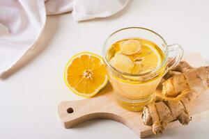 biologique en bonne santé thé avec gingembre et citron dans une tasse sur le table photo