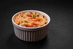 délicieux bouilli riz avec des légumes poivrons, vert petits pois, sel, épices et herbes photo