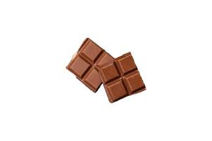 délicieux sucré Lait Chocolat cassé dans cubes sur une en bois Coupe planche photo